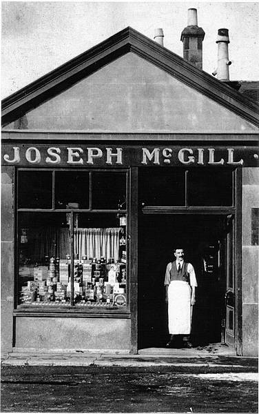 Joe McGill outside his shop